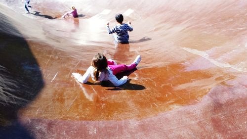 High angle view of children playing on slide