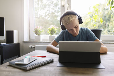 Male teenager studying at home