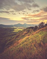 Scenic view of land against sky during sunset