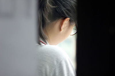 Close-up portrait of young woman at home