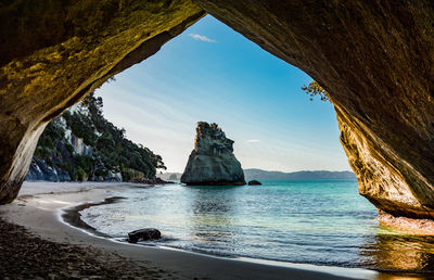 Scenic view of sea seen through cave