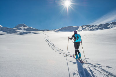 Rear view of man skiing on snowcapped mountain