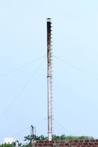 Low angle view of telephone pole against clear sky