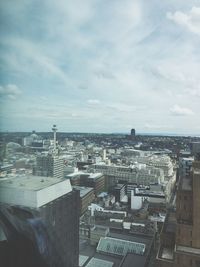 Cityscape against cloudy sky