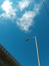 Low angle view of street light against building