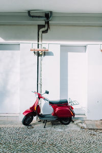 Motor scooter parked outside building