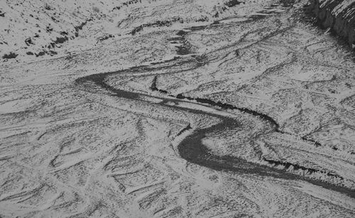 High angle view of tire tracks on sand