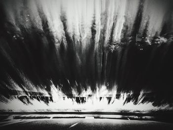 Silhouette trees against sky at night