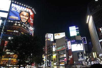 Low angle view of illuminated buildings in city at night
