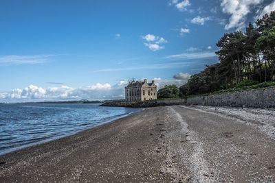 View of beach against cloudy sky