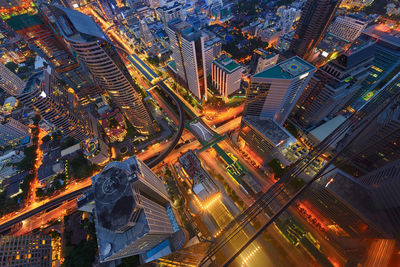 Aerial view of illuminated cityscape during sunset