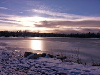 Snow covered landscape at sunset