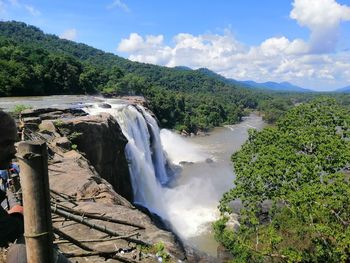 Scenic view of waterfall against sky