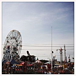 Low angle view of ferris wheel against sky