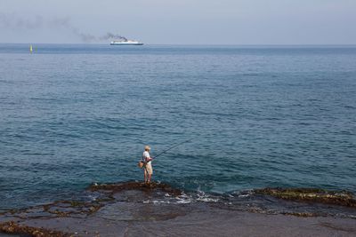 Man standing on beach against sky