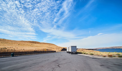 Road by sea against sky