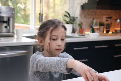 Portrait of cute girl little helper in the kitchen 