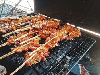 High angle view of meat on barbecue grill