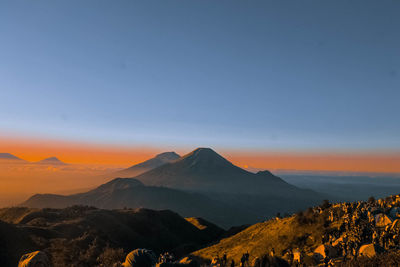 Scenic view of snowcapped mountains against sky during sunset