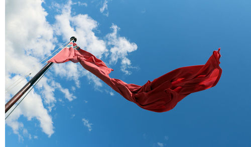 Low angle view of flags against sky