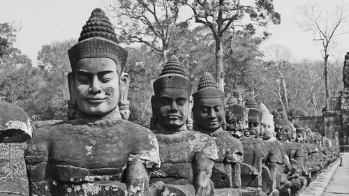 Statues against trees and plants