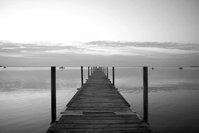 Pier amidst sea against sky