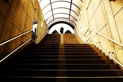 Low angle view of people walking on stairs