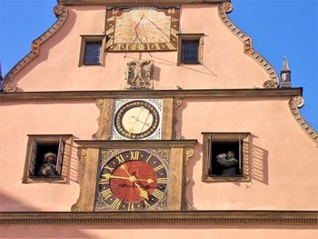 Low angle view of clock tower against building