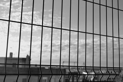 Close-up of suspension bridge against sky