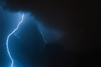 Lightning in the night sky. thunderstorm over the city. stormy dark clouds and rainy weather.