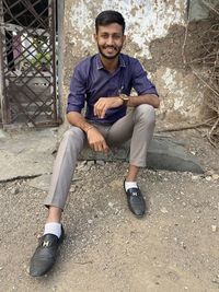 Portrait of young man sitting outdoors