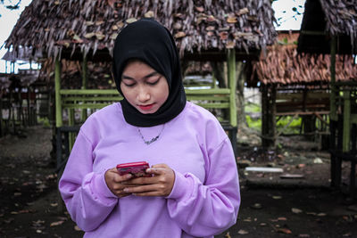 Portrait of teenage girl holding mobile phone