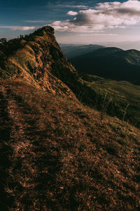 Aerial view of land and mountains against sky
