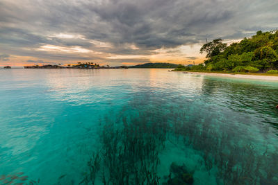 Scenic view of lake against cloudy sky