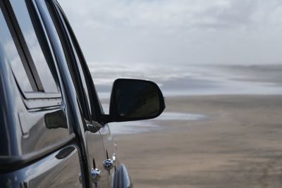 Close-up of vintage car on beach