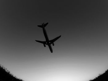 Low angle view of airplane against clear sky