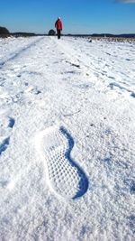 High angle view of shoe print on snow covered field