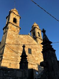 Low angle view of bell tower against sky