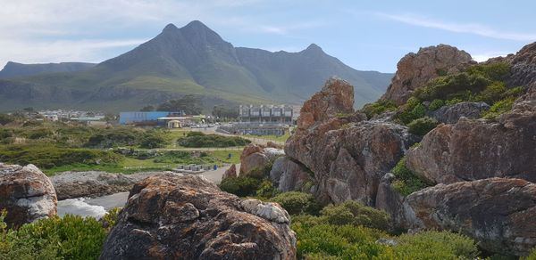 Scenic view of rocks and mountains against sky