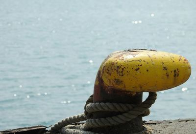 Close-up of rope tied to bollard