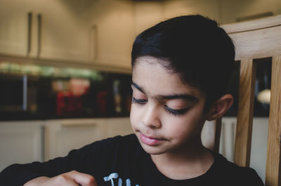 Portrait of teenage girl sitting at home