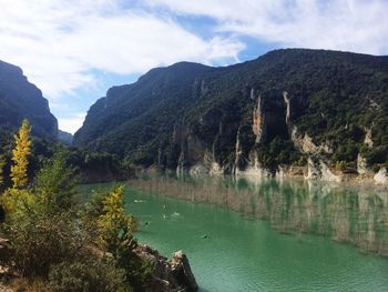 Scenic view of lake and mountains against sky