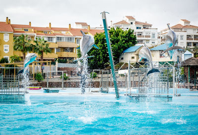 Water fountain in swimming pool in city