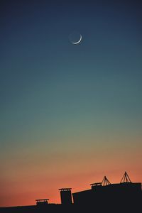Silhouette of moon against sky at sunset