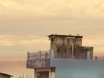Buildings against cloudy sky
