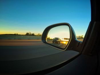 Reflection of sky on side-view mirror