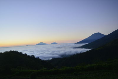 Scenic view of silhouette mountains against sky during sunset