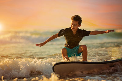 Portrait of young man surfing in sea