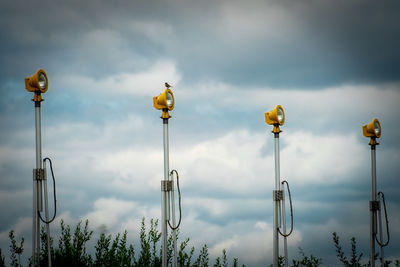 Low angle view of street lights against sky