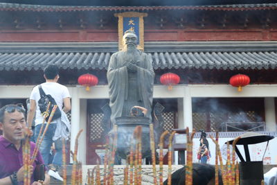 Statue of buddha against temple